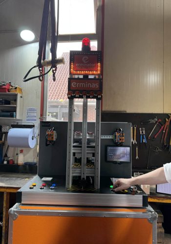 'Erminator Free-Fall Tower' in workshop environment; an operator starts the test setup by pressing the green button